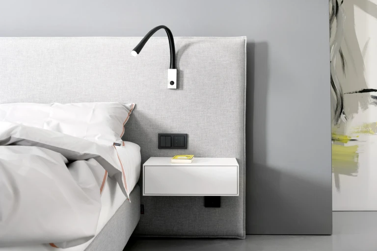 Flaches Boxspringbett mit gepolsterten Wandpaneel in flacher Kissenoptik